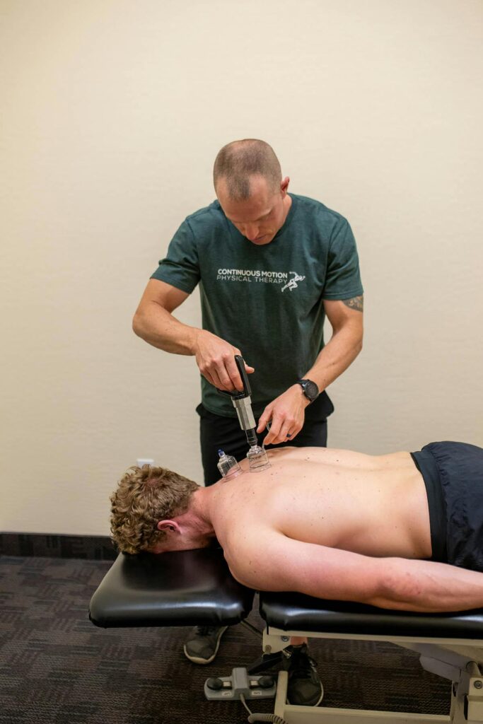 A man is getting a back massage in a doctor's office.